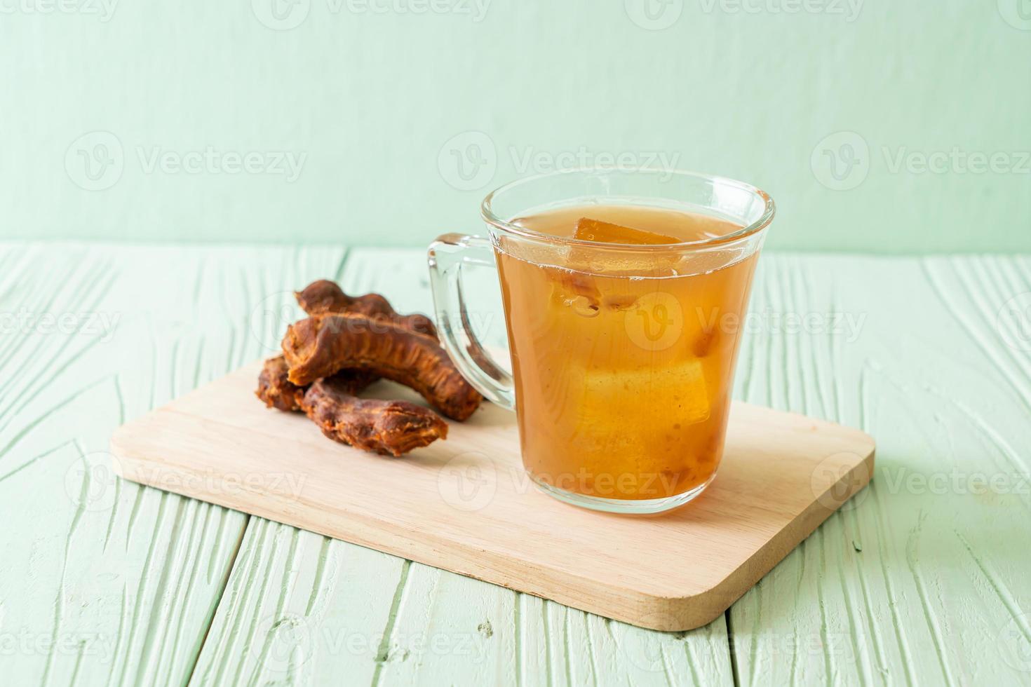 Delicious sweet drink tamarind juice and ice cube photo