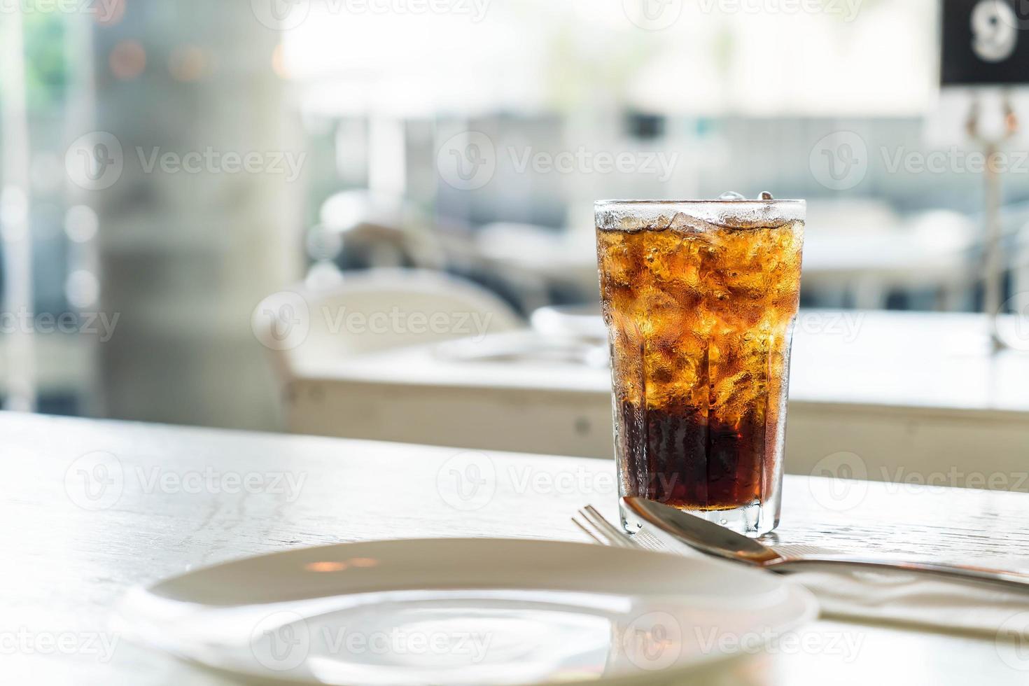 Iced cola glass on the table photo