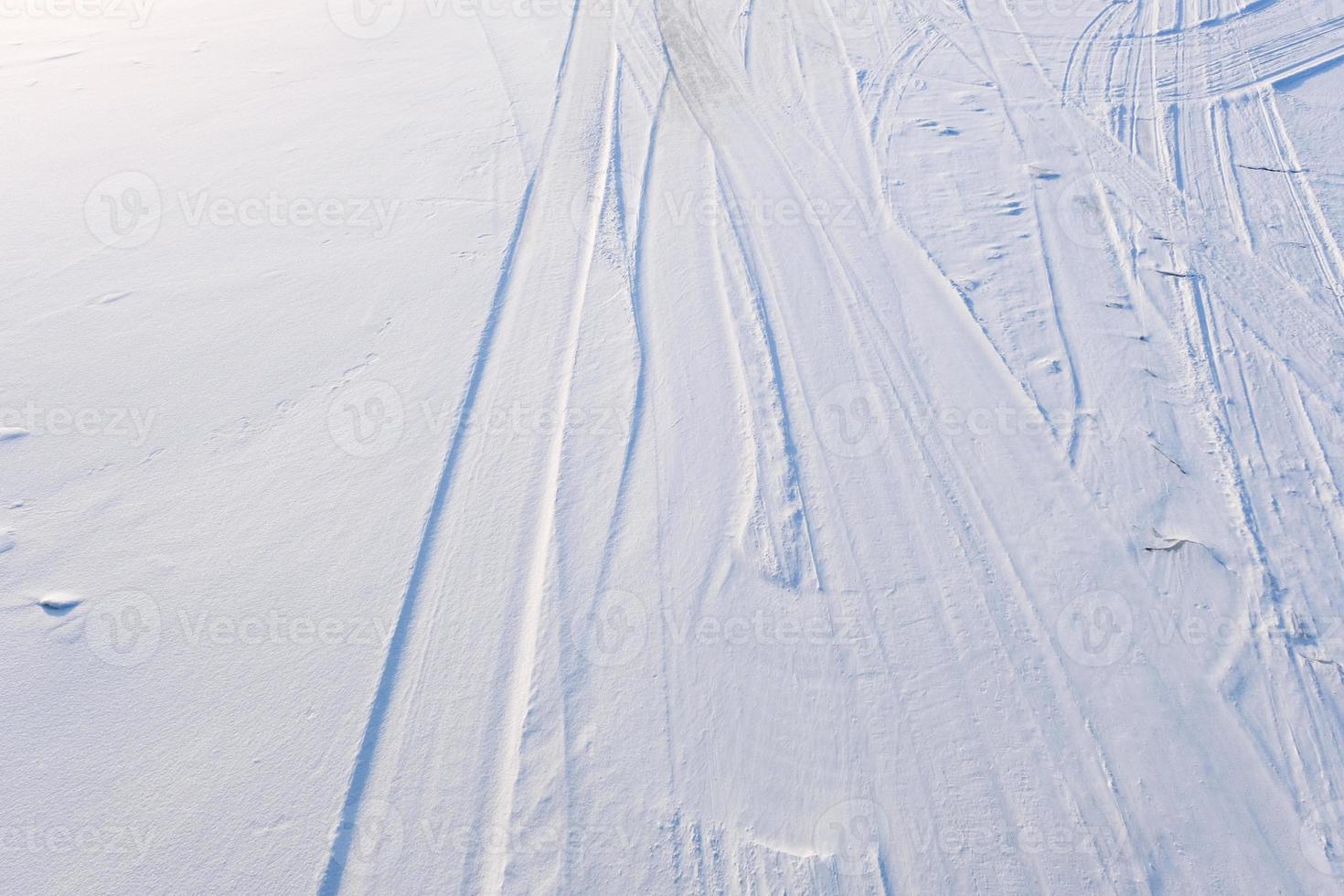 ski trail in the white and blue snow on mountain surface photo