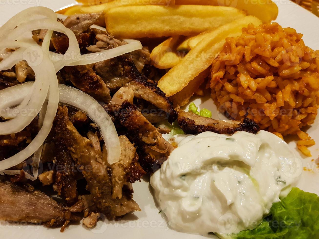 Greek Food Gyros with Pommes frites and salad photo