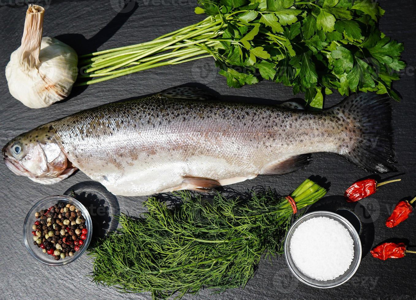 Fresh rainbow trout with herbs and spices for bbq photo