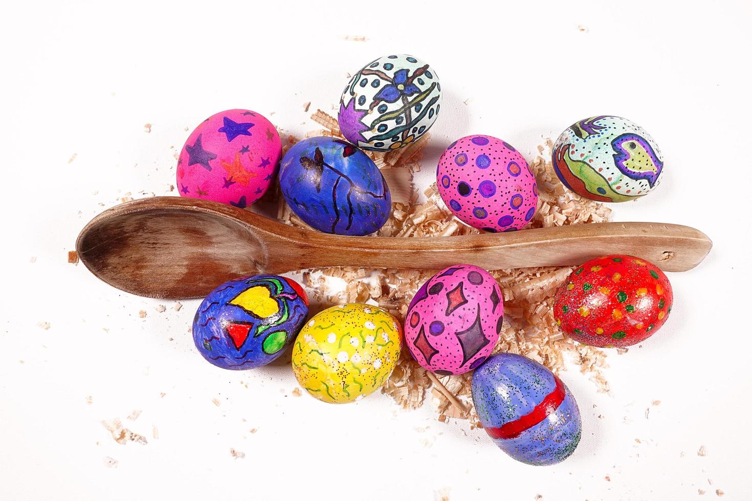 coloridos huevos de pascua pascual y celebración de cuchara de madera foto