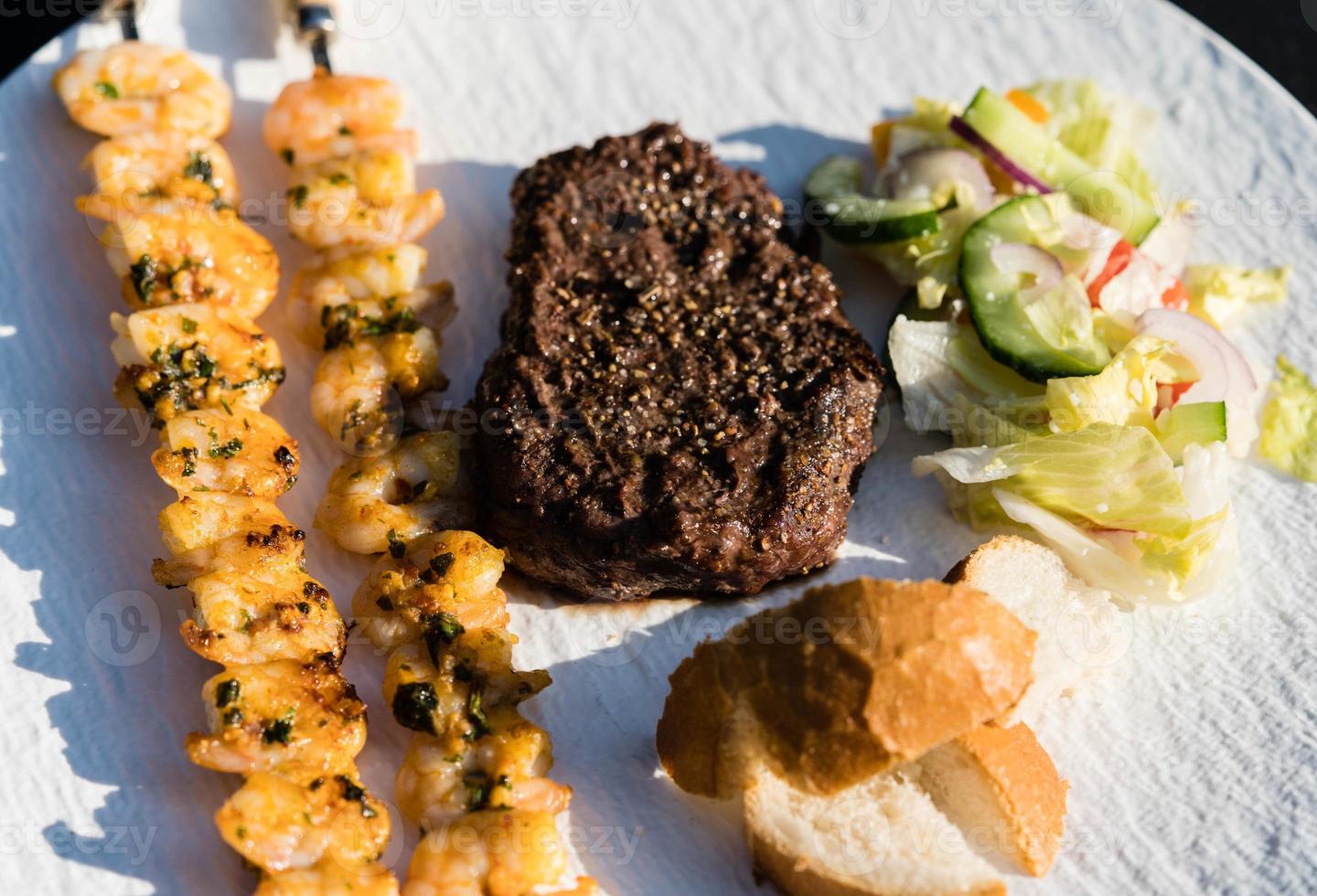 Surf and turf fillet steak and white tiger prawns photo