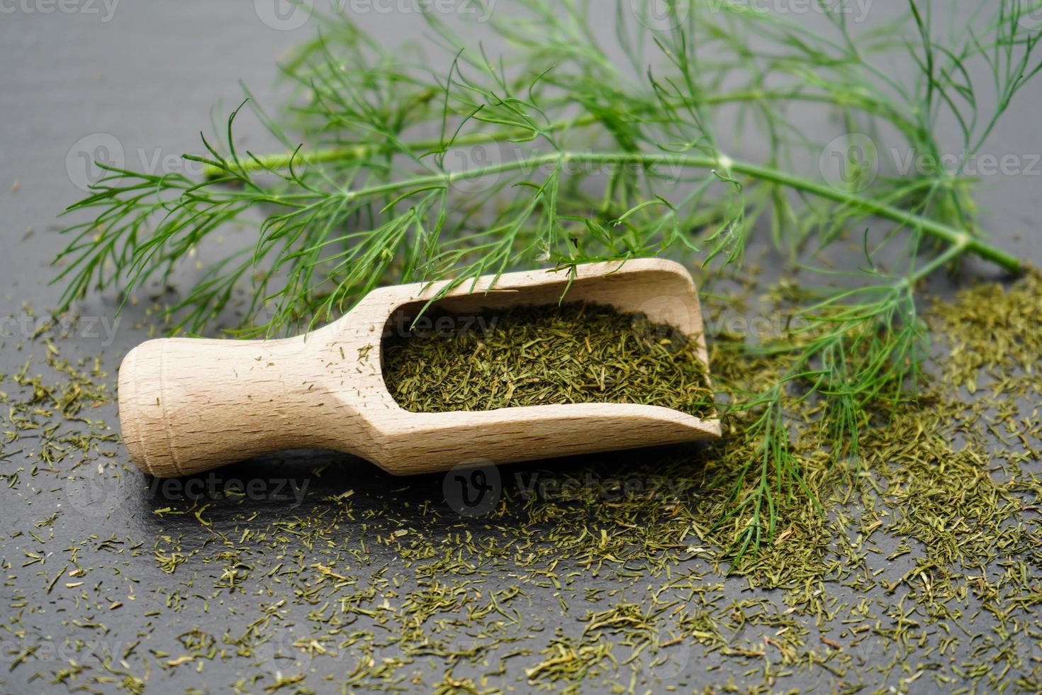 Dill Anethum graveolens and a wooden spoon photo