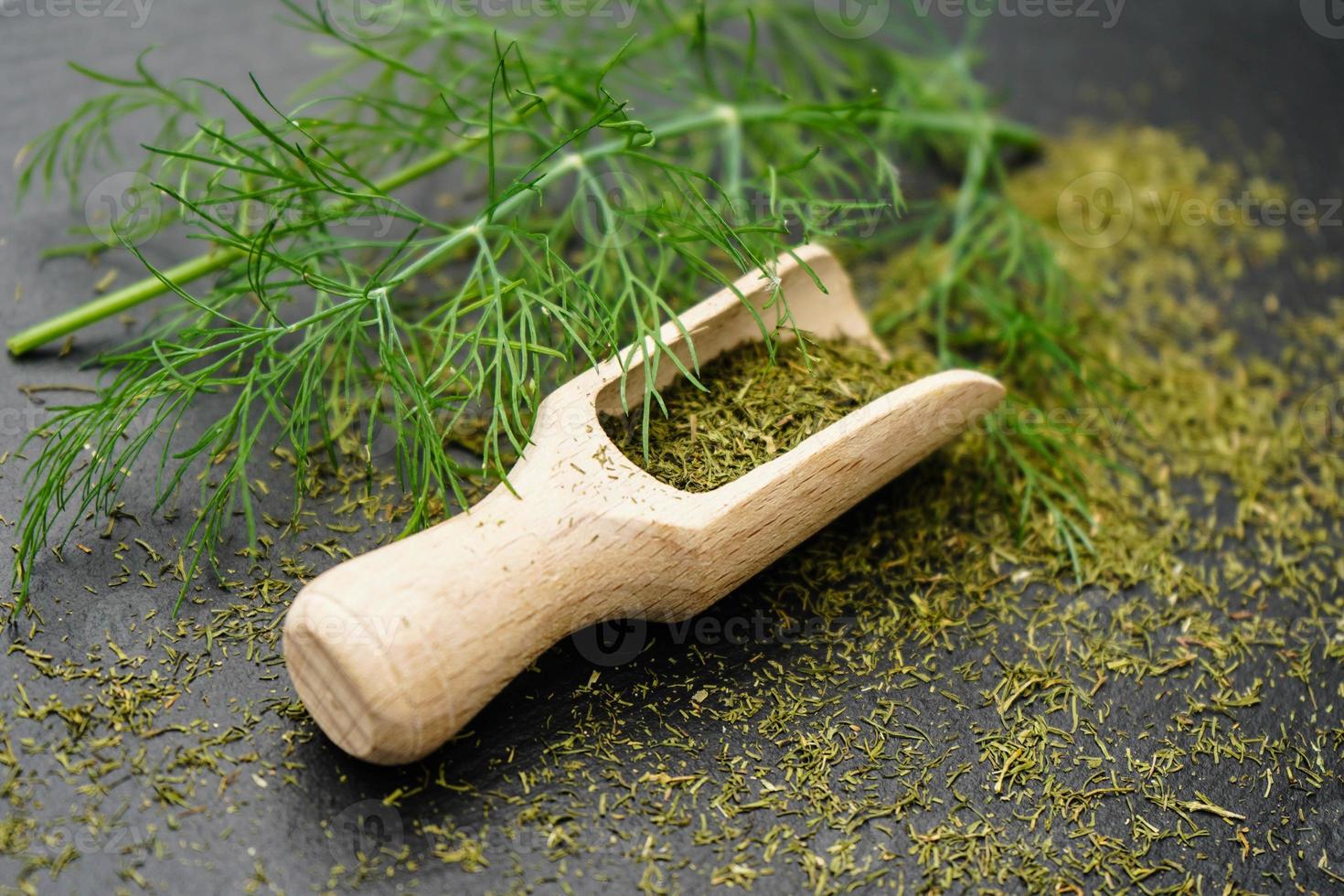 Dill Anethum graveolens and a wooden spoon photo