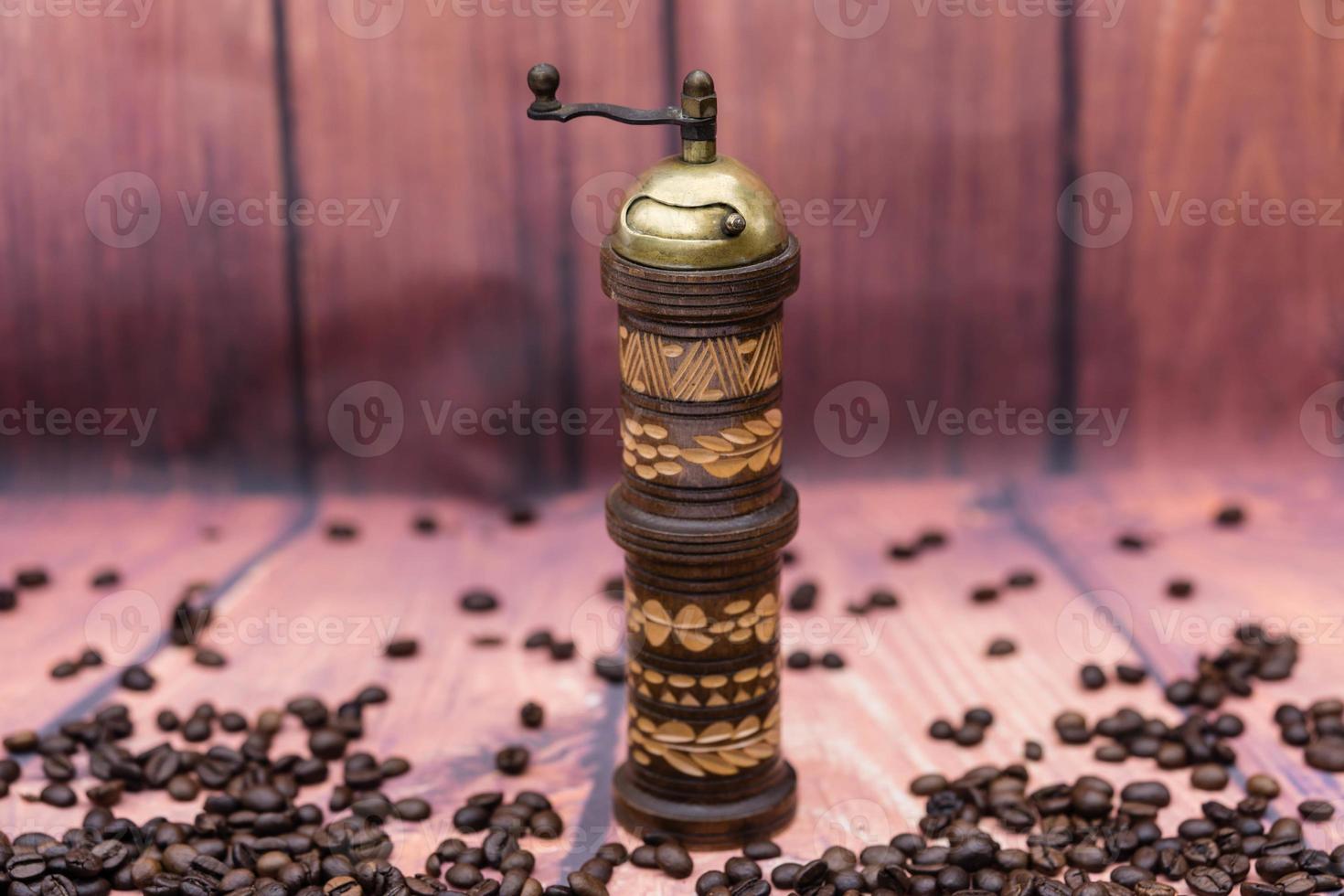 roasted Coffee beans and a vitage coffee grinder photo