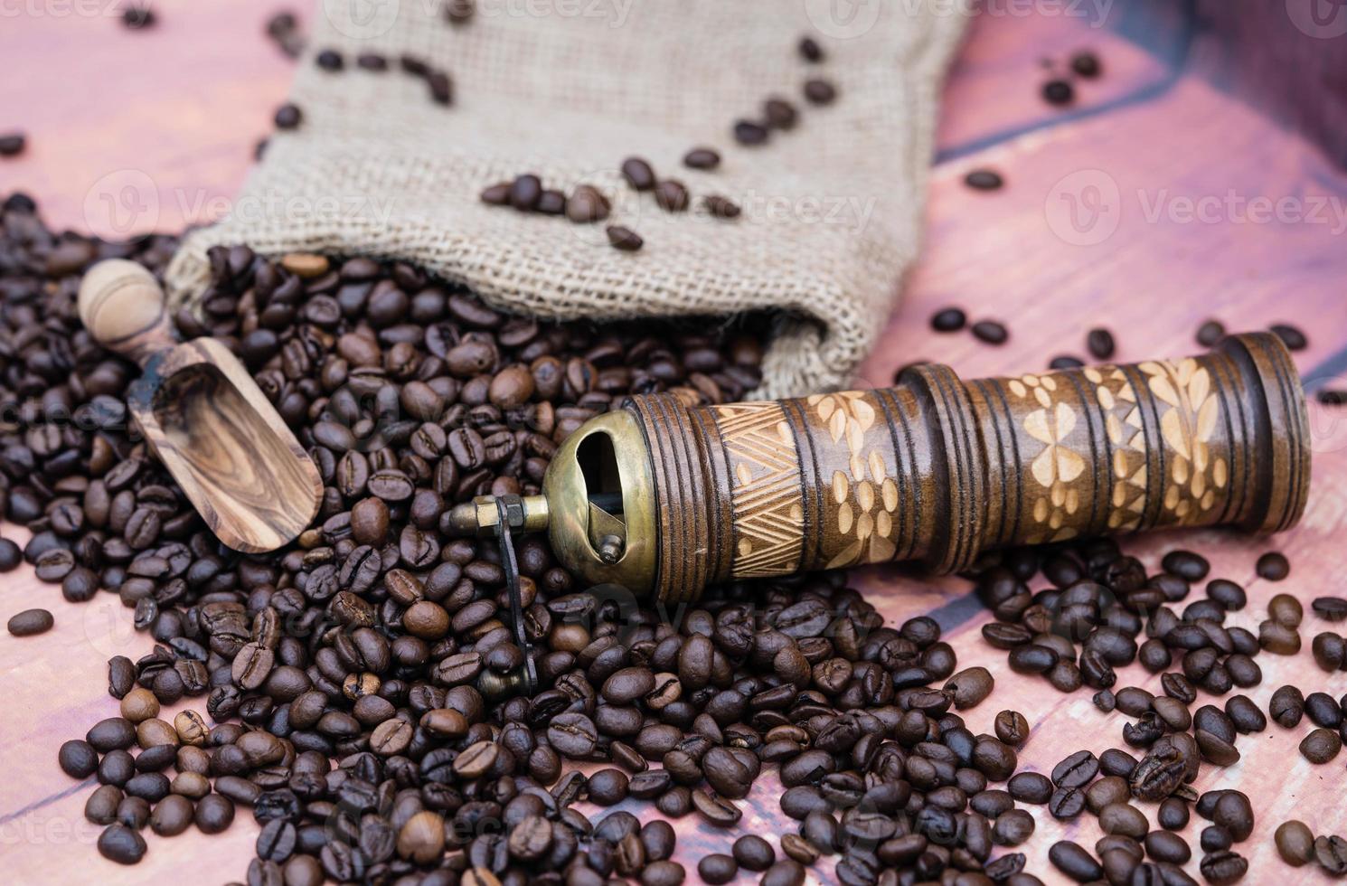roasted Coffee beans and a vitage coffee grinder photo