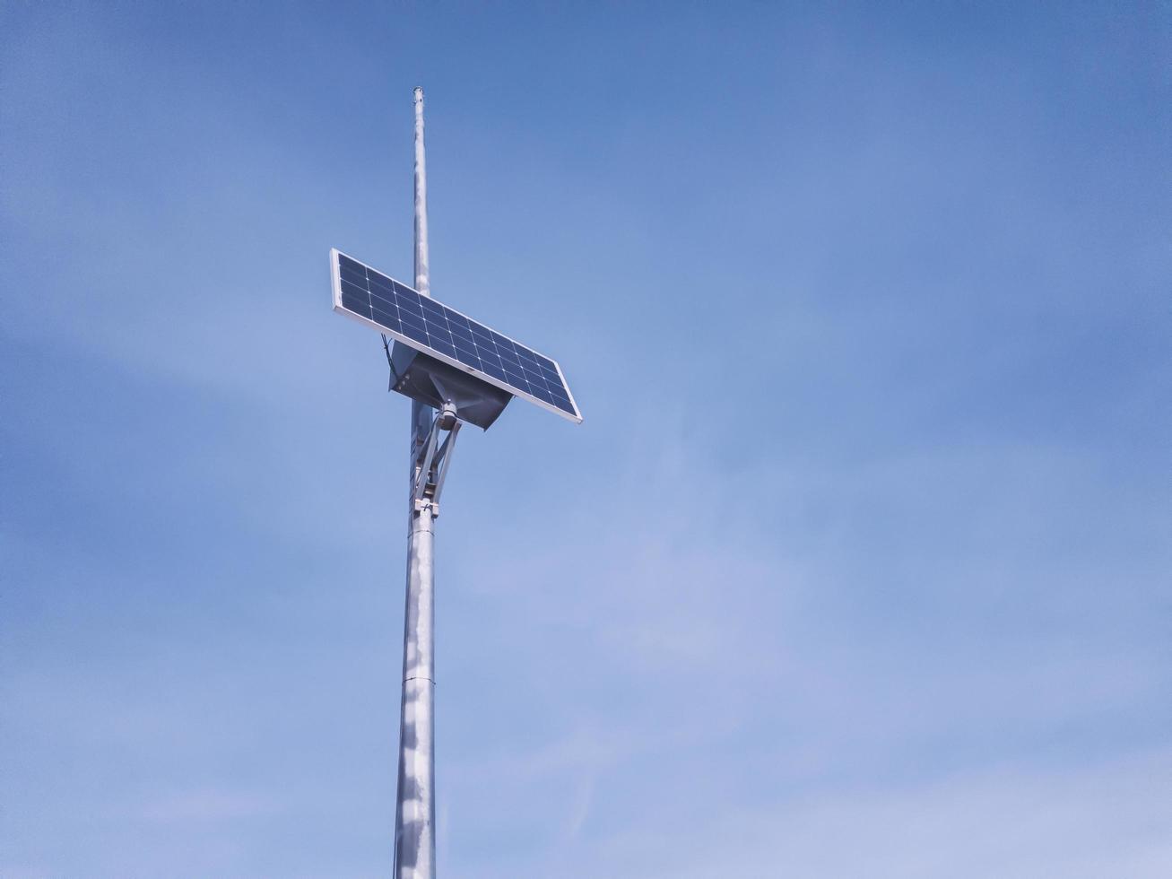 Small solar panel mounted on a metal pole. photo