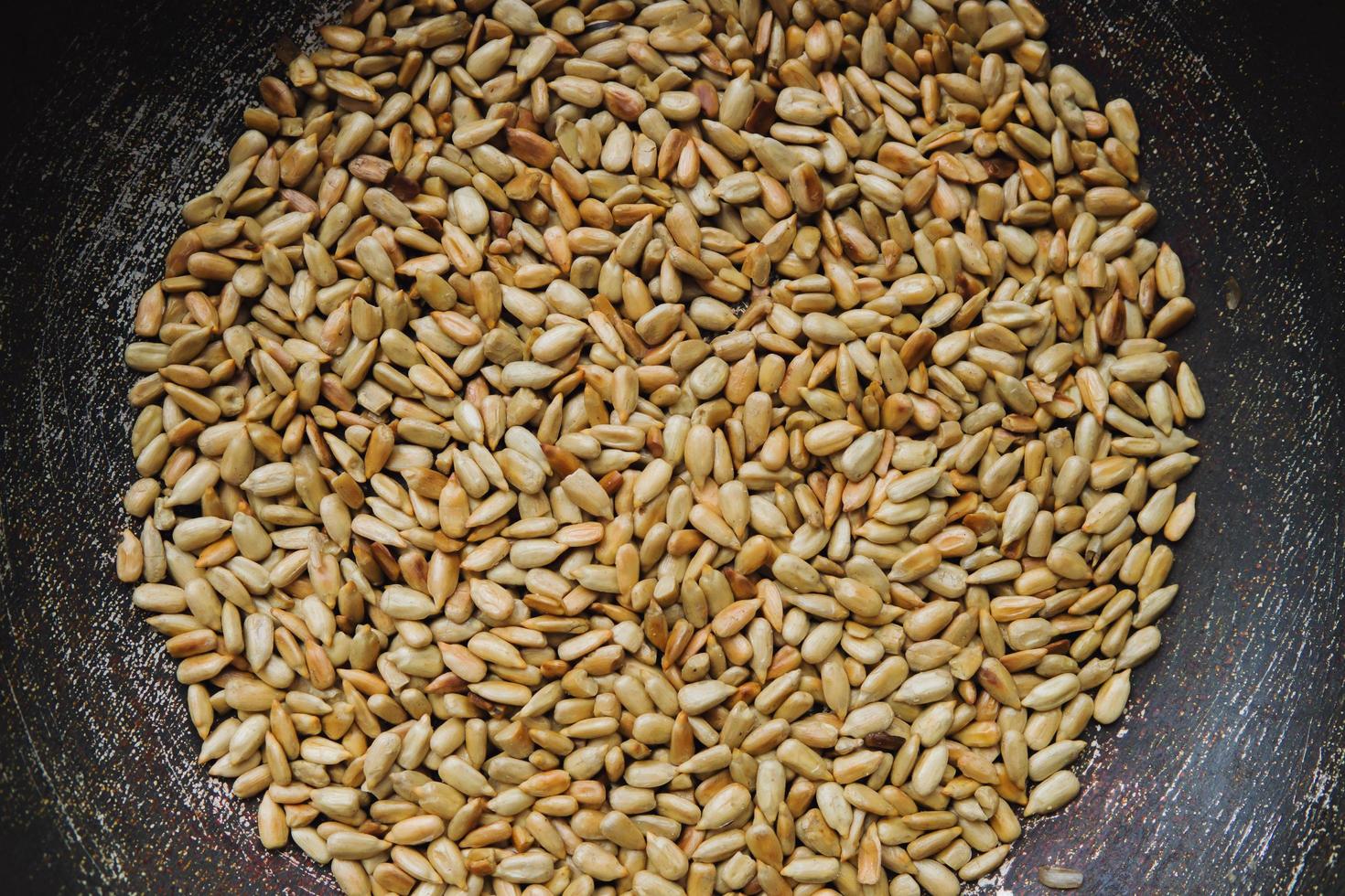 Peeled roasted seeds in a steel pan. photo