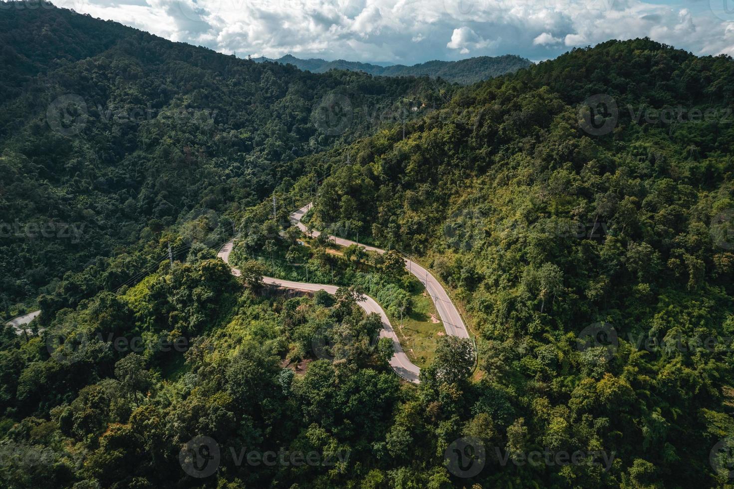 mountain road and green trees from above photo
