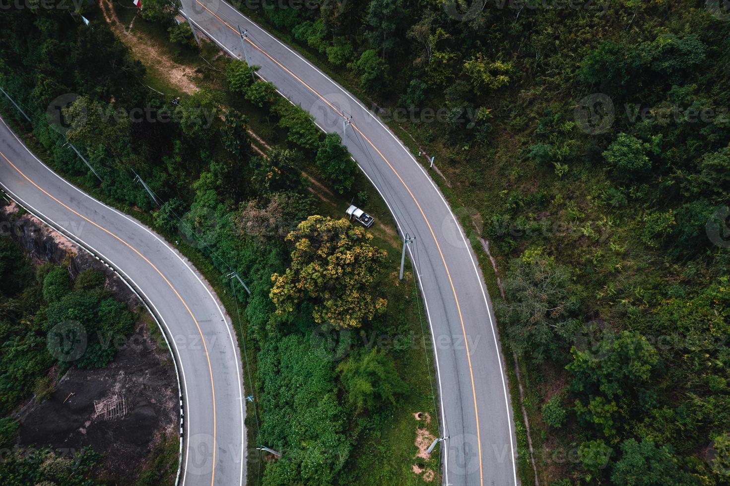 mountain road and green trees from above photo