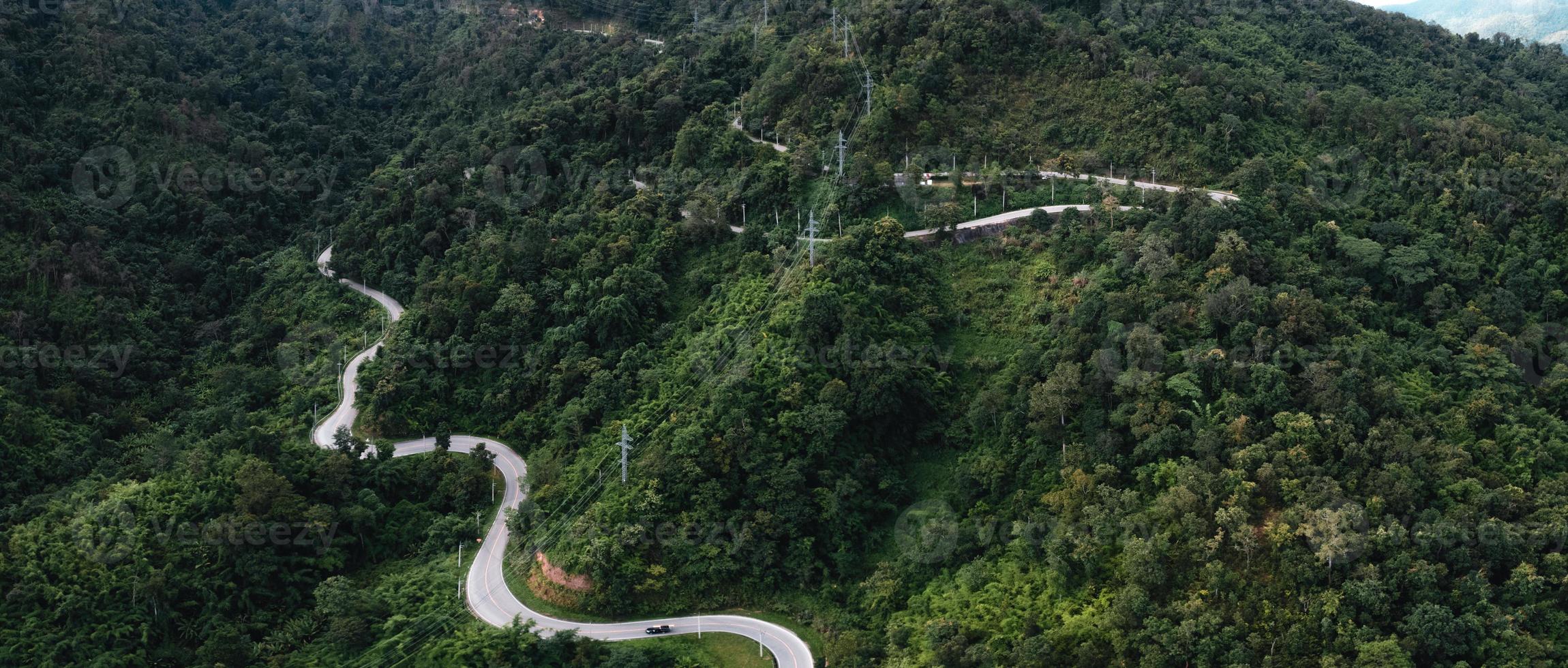 mountain road and green trees from above photo