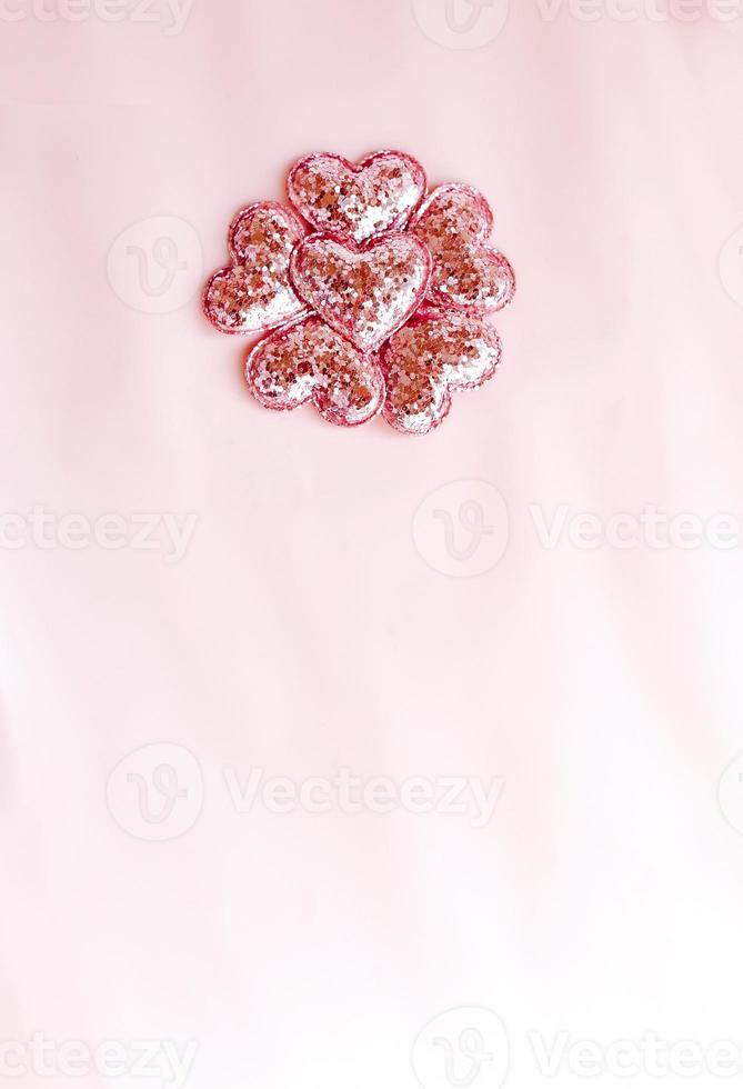 Background with pink glittered hearts. Pink paper top view, flat lay photo