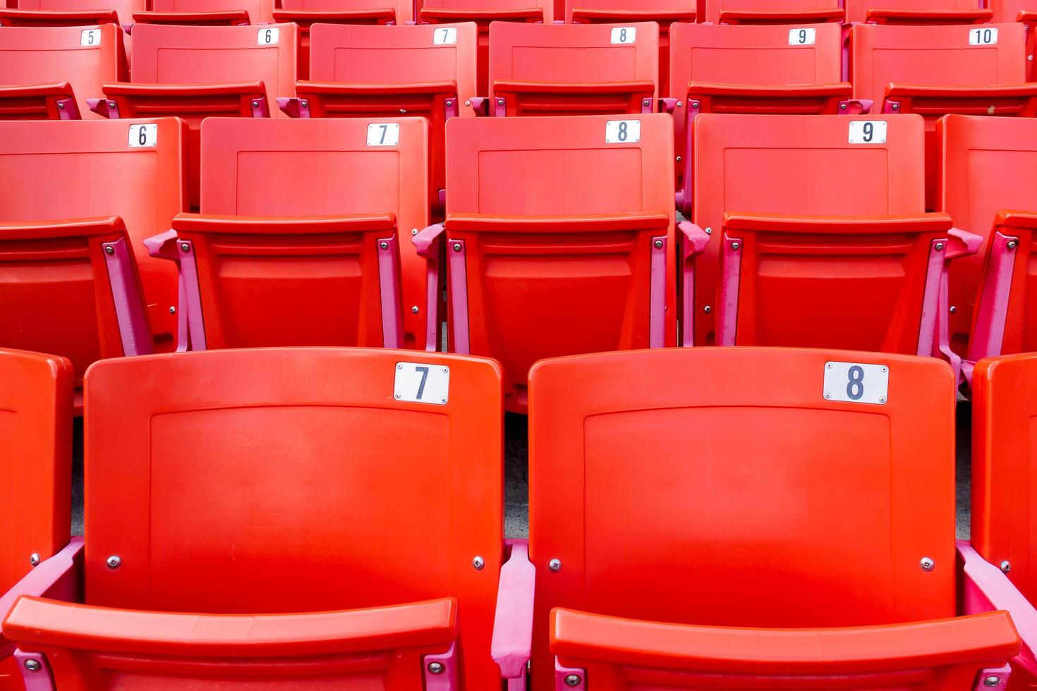 fila de sillas plegables rojas en un estadio. foto