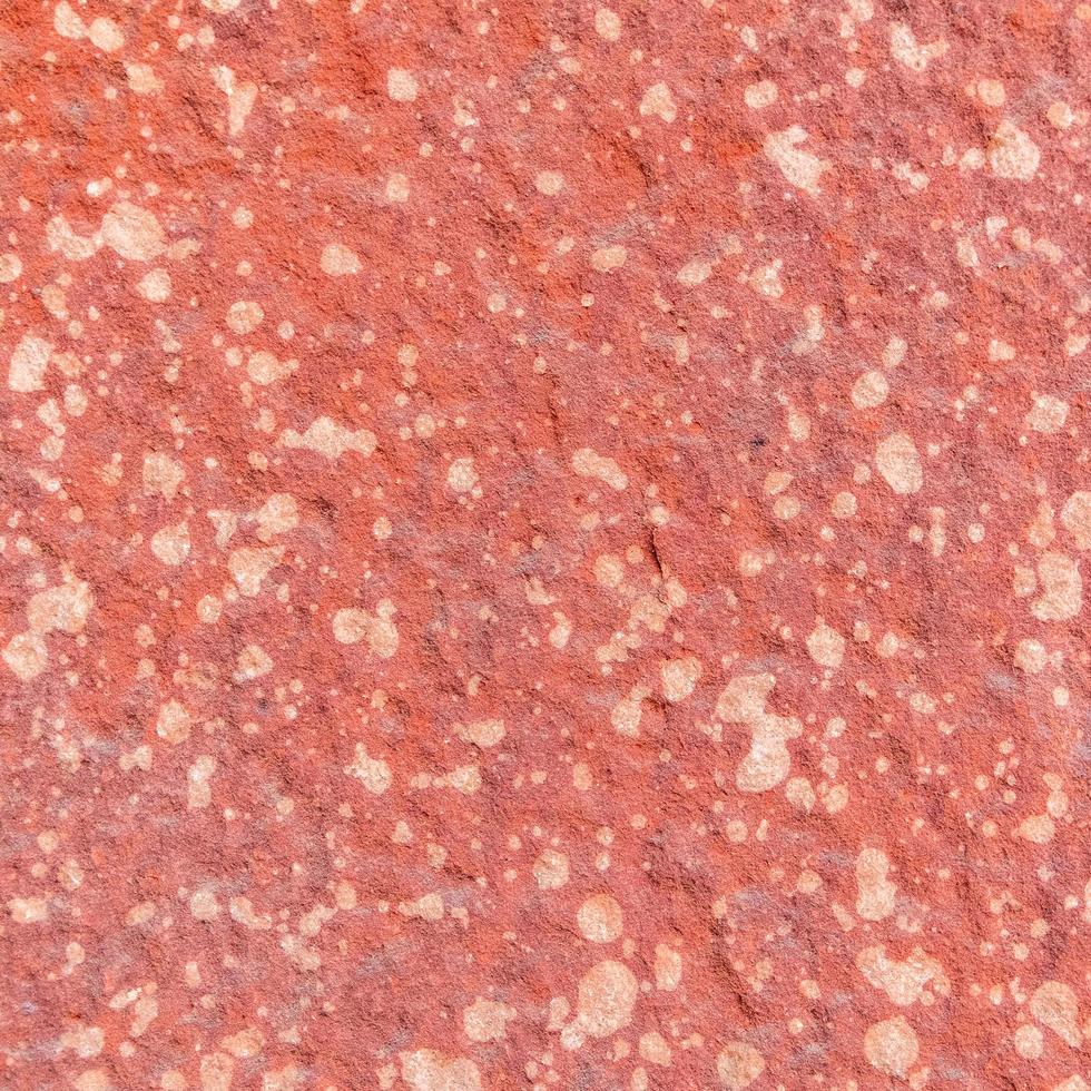 Fondo de textura de piedra rugosa roja. foto