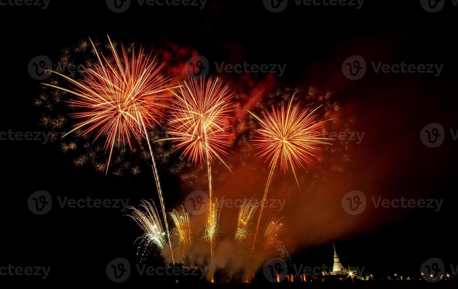 Huge, colorful fireworks over the rice fields at dusk. photo