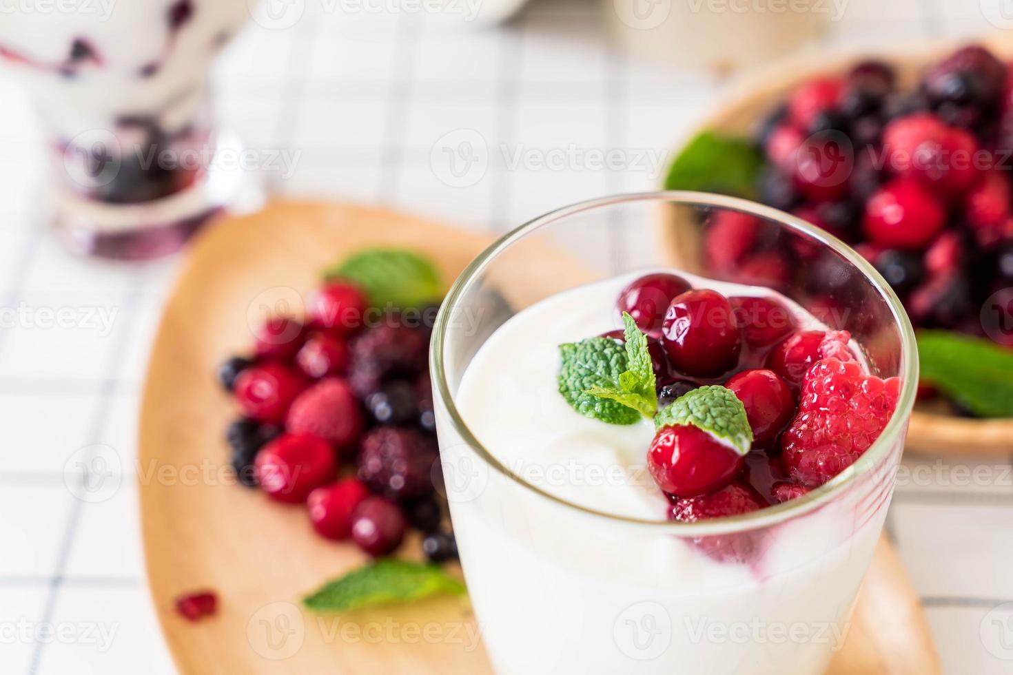 Yogurt with mixed berries on the table photo