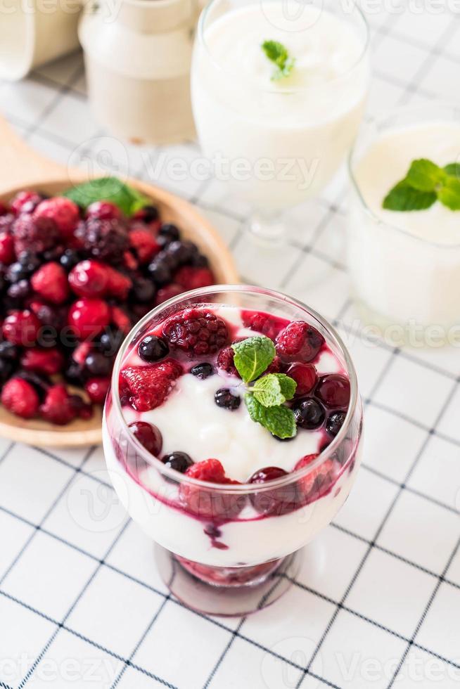 Yogurt with mixed berries on the table photo