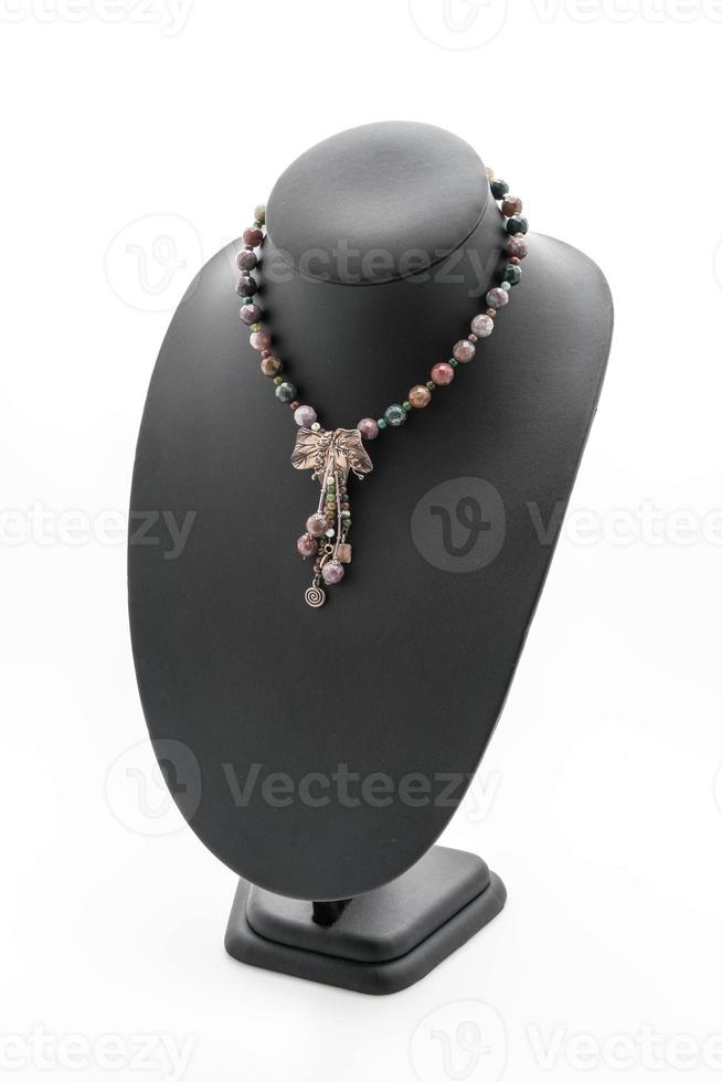 Beautiful and luxury necklace with jewelry stand neck on white photo