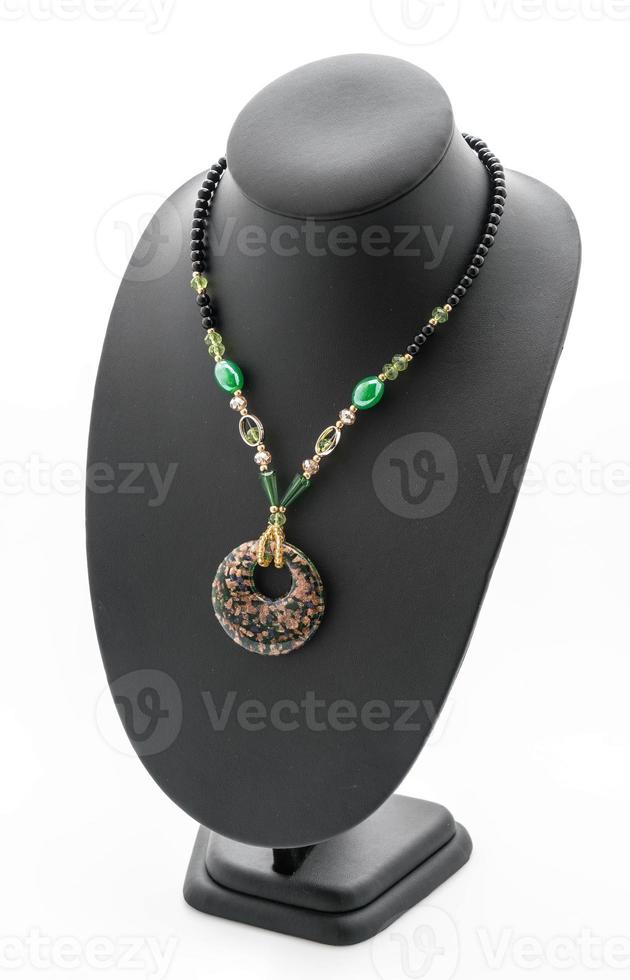 Beautiful and luxury necklace with jewelry stand neck on white photo