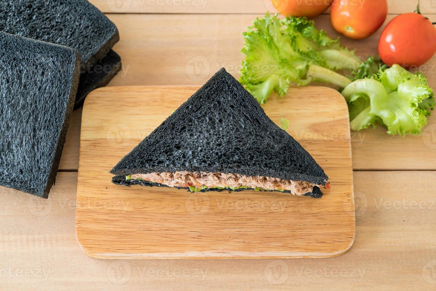 Tuna charcoal sandwich on wood board photo