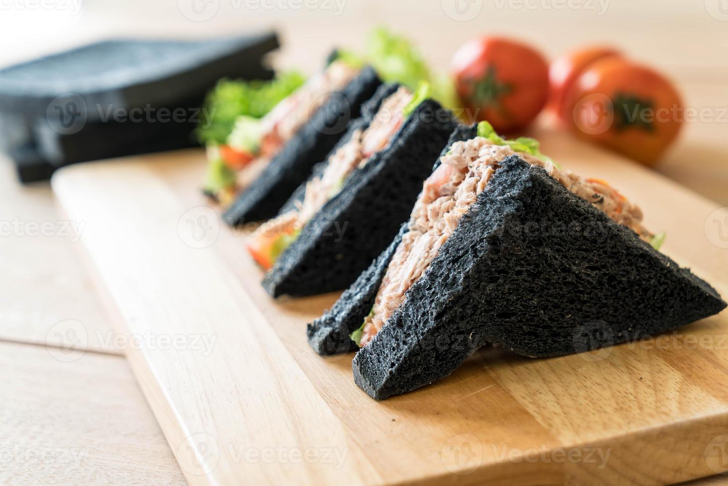 Tuna charcoal sandwich on wood board photo