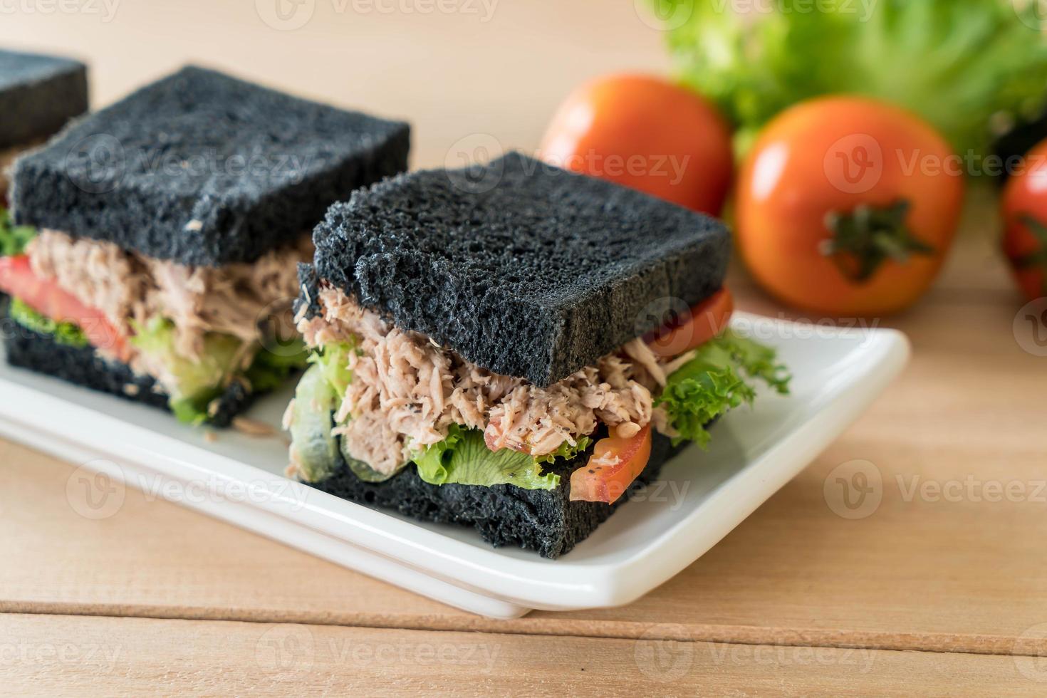 Tuna charcoal sandwich on wood table photo