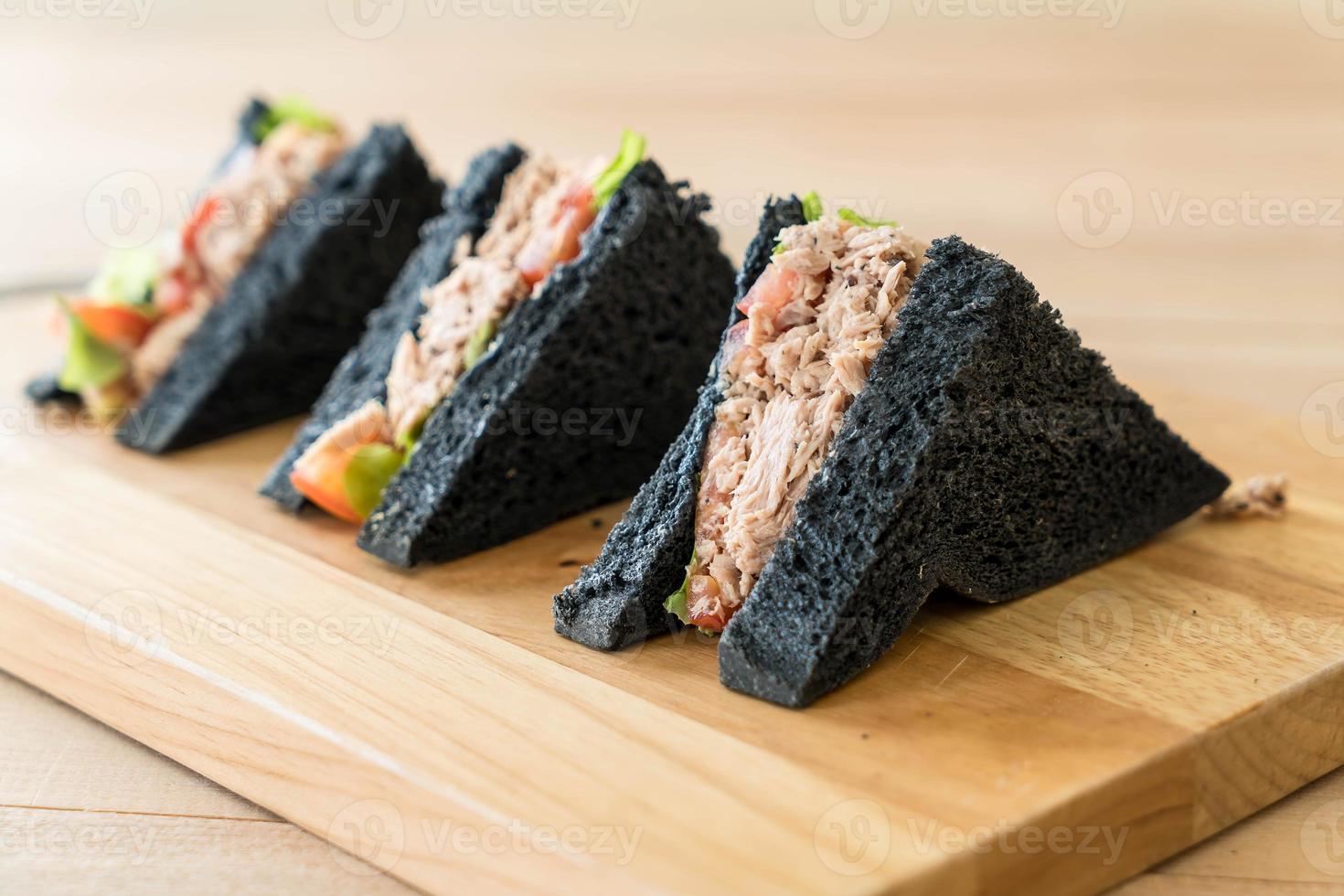 Tuna charcoal sandwich on wood table photo