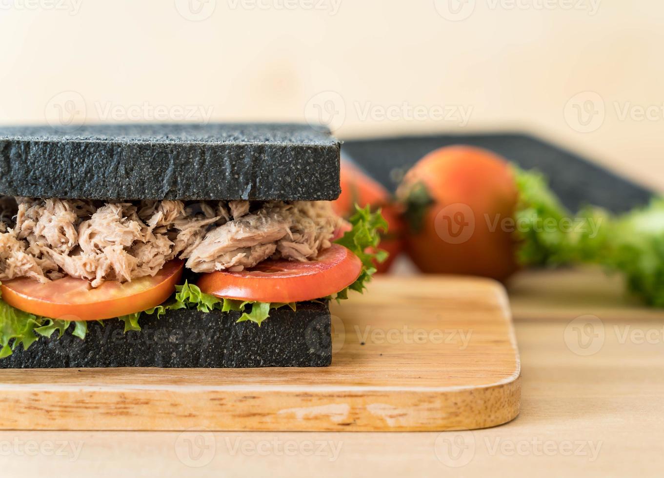Tuna charcoal sandwich on wood table photo