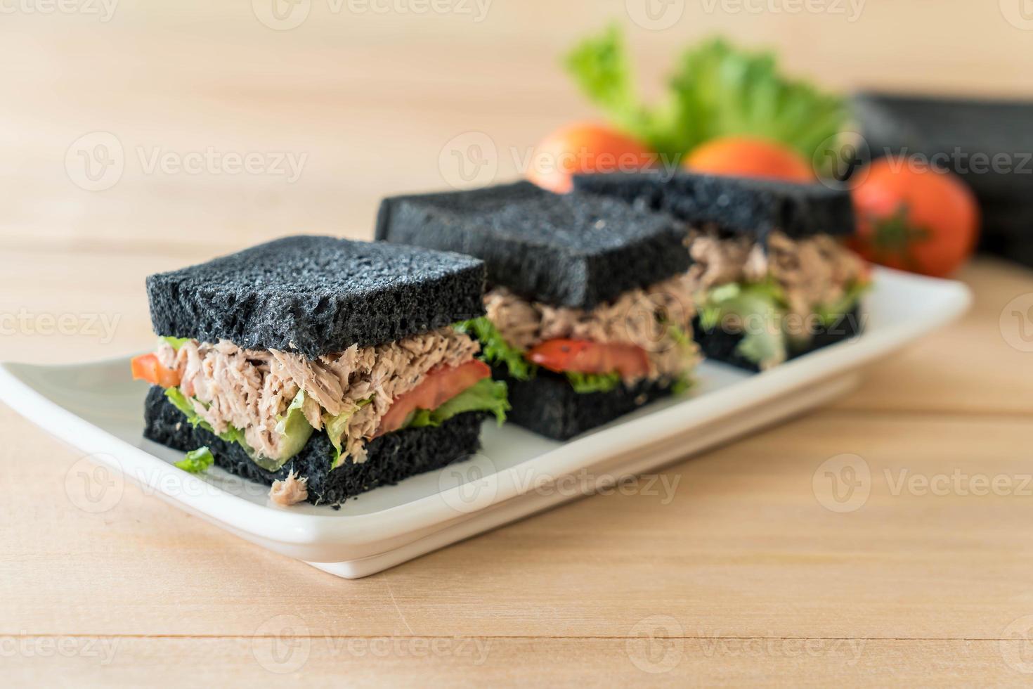 Tuna charcoal sandwich on wood table photo