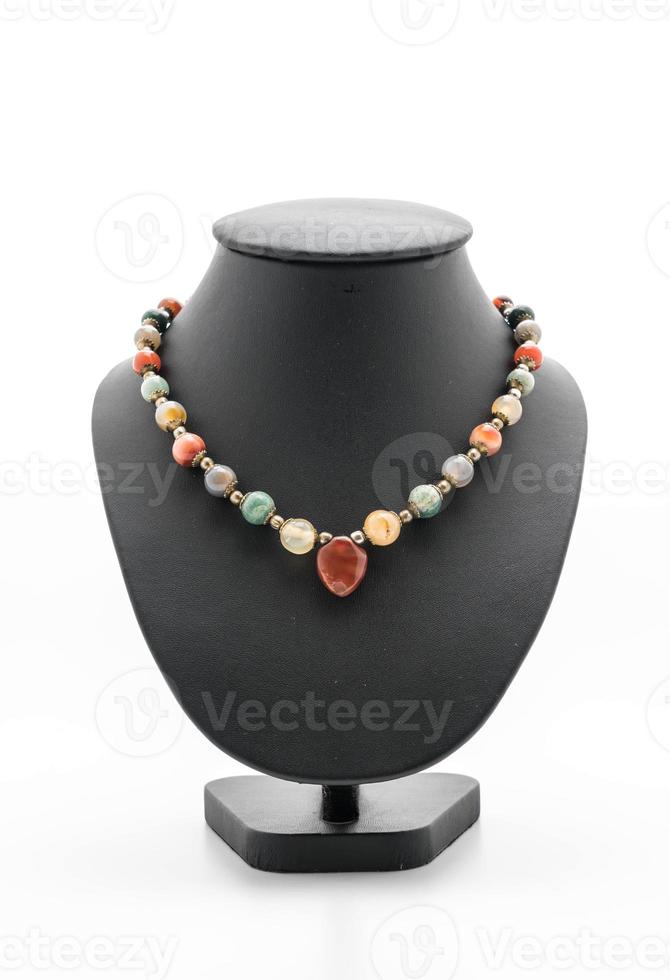 Beautiful and luxury necklace with jewelry stand neck on white photo