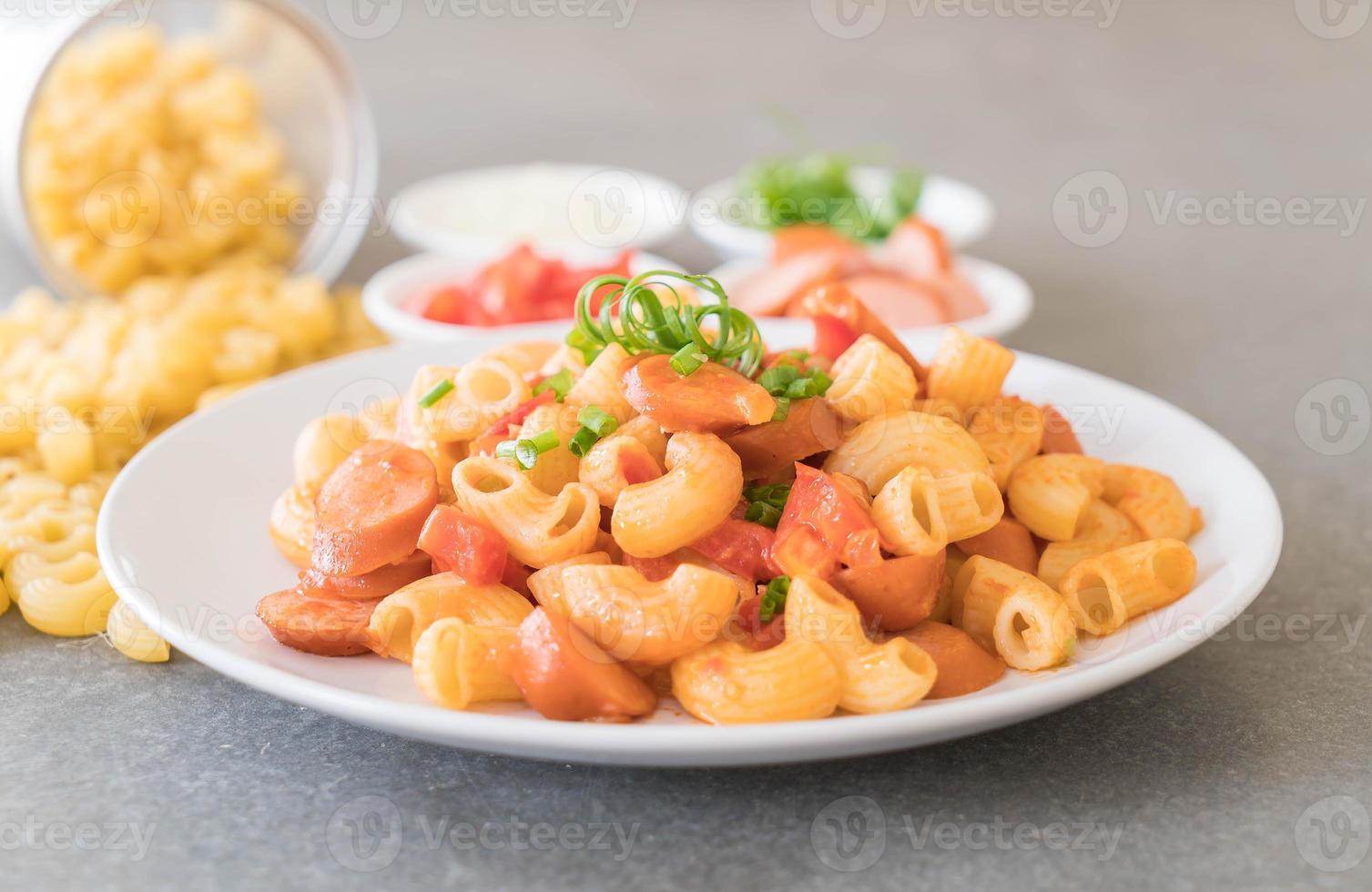 Macaroni with sausage on the table photo