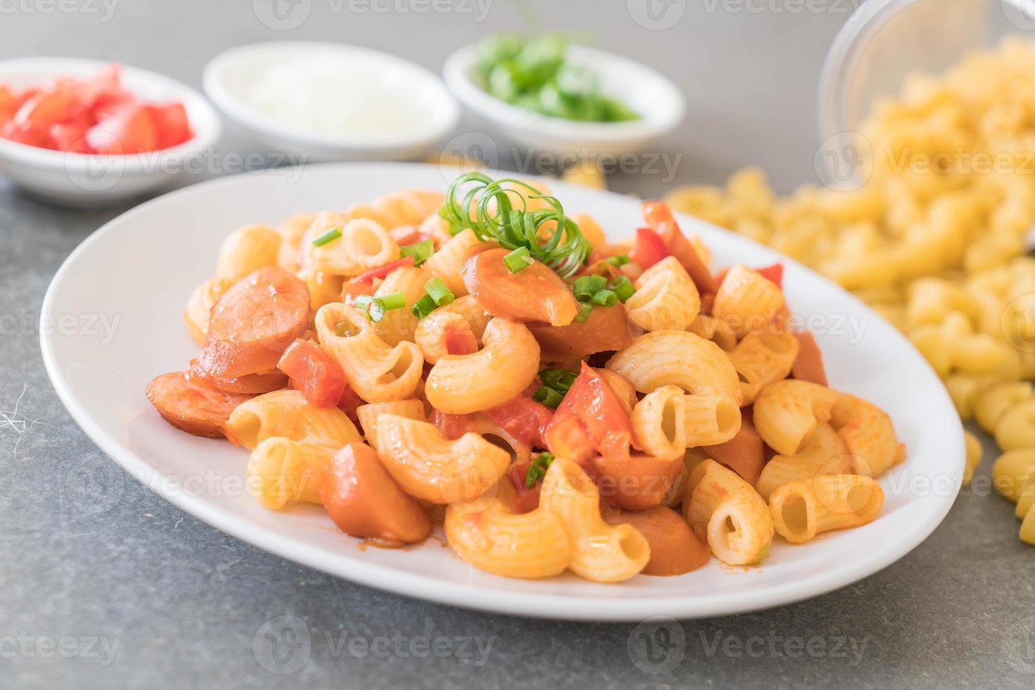 Macaroni with sausage on the table photo