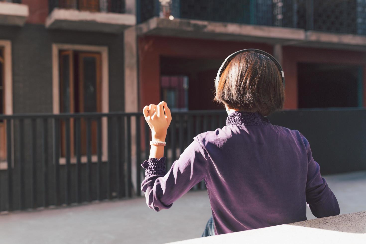 Happy young asian woman listening to music with headphones photo