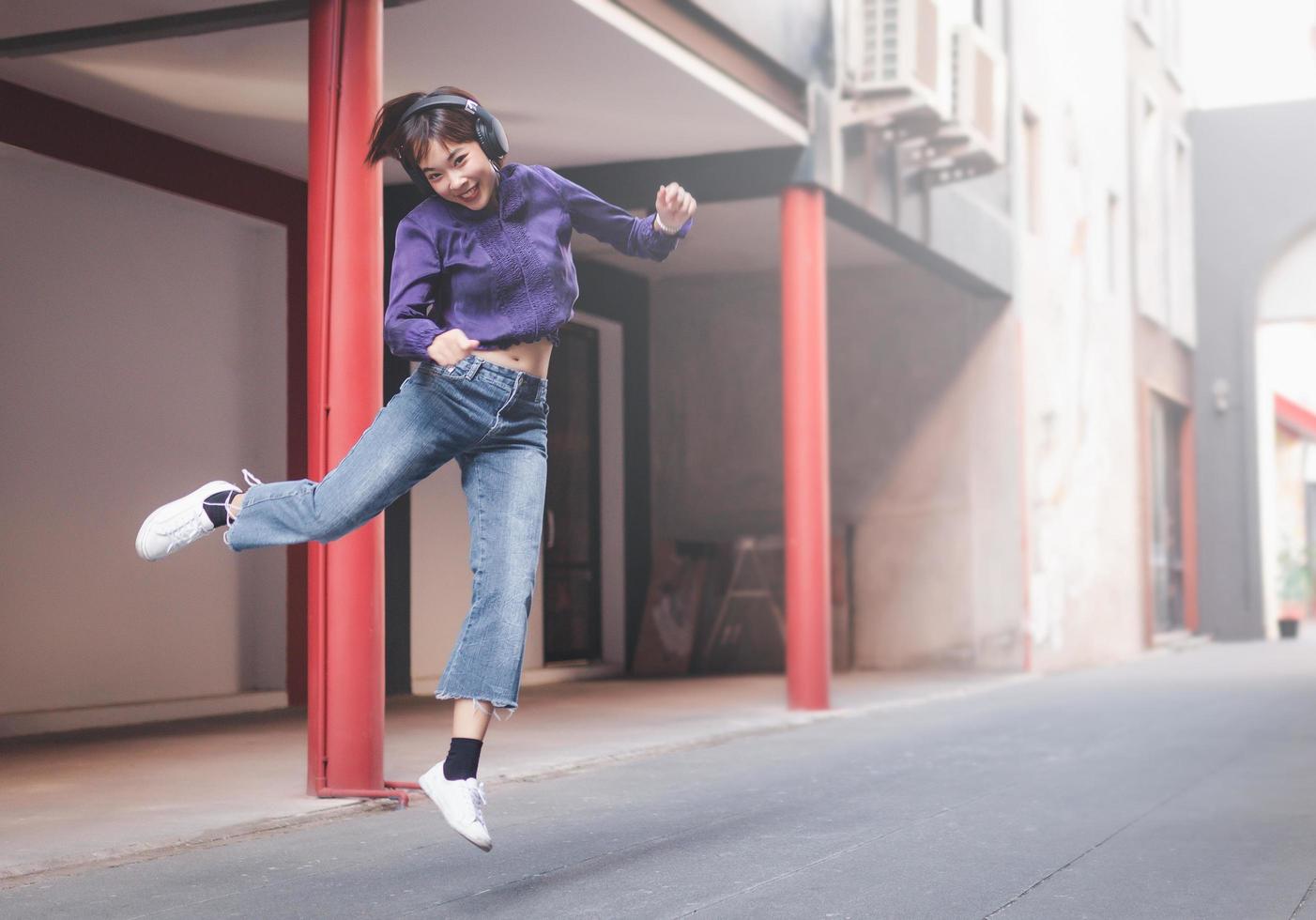 Happy young asian woman listening to music photo