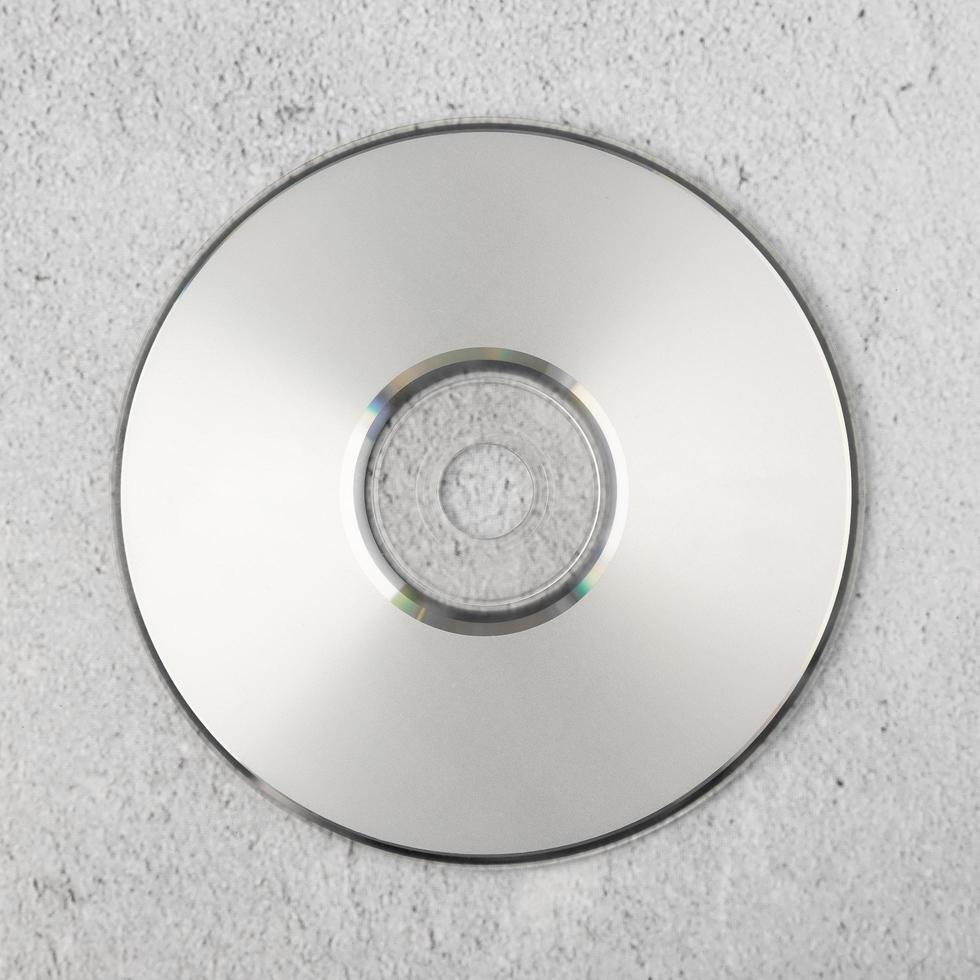 Realistic white cd template on white cement background photo