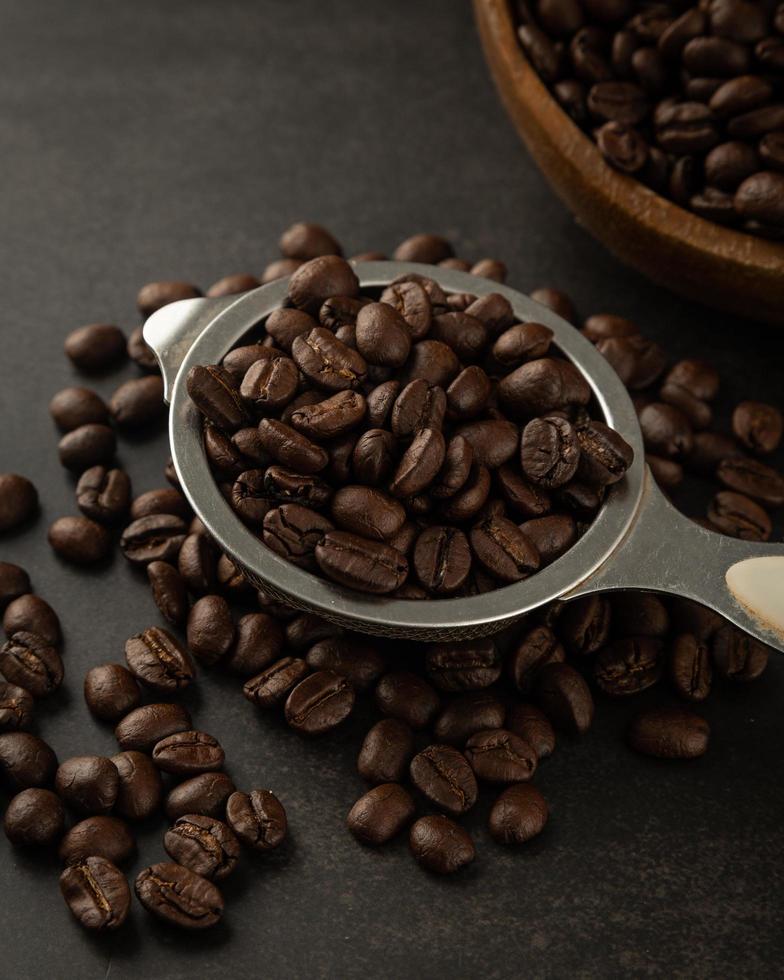 Coffee beans in wooden bowl on grunge background photo