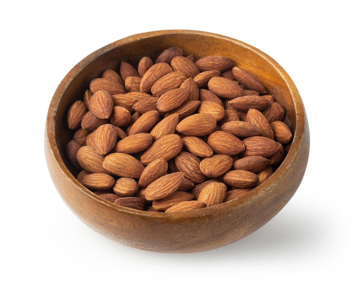 Almonds in wooden bowl isolated on white background with clipping path photo