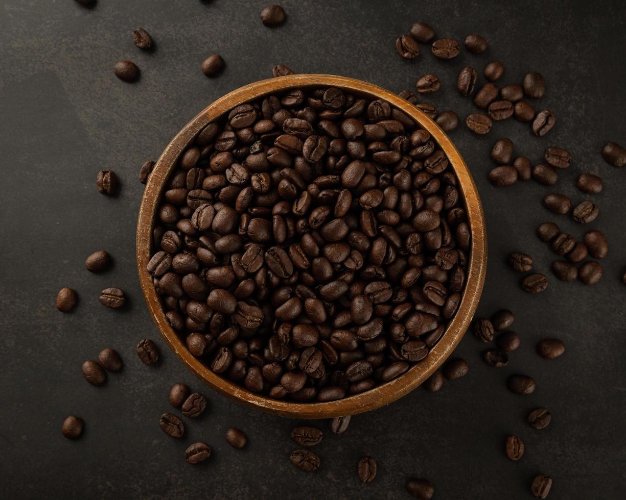 Coffee beans in wooden bowl on grunge background photo