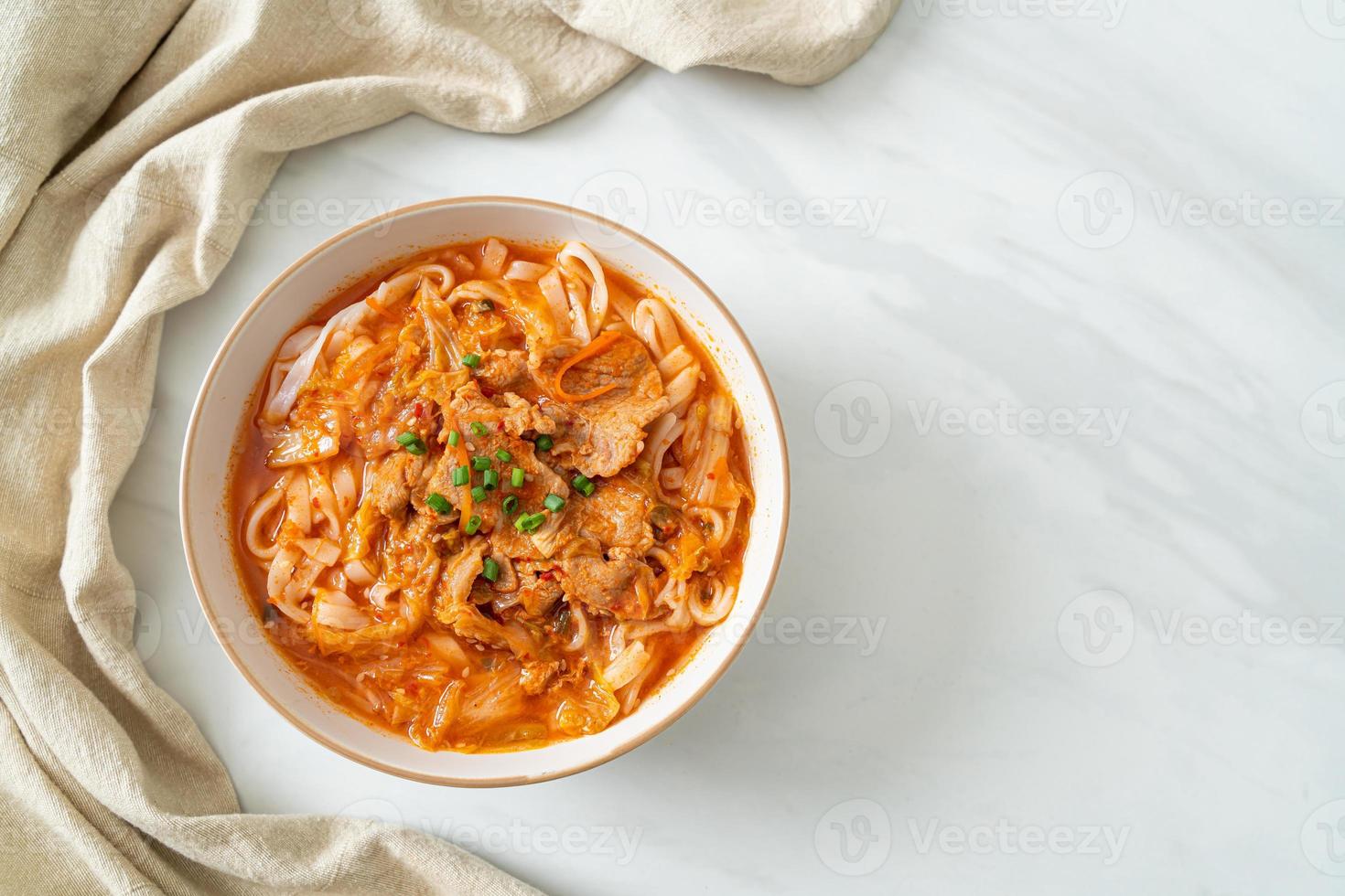 Korean udon ramen noodles with pork in kimchi soup photo