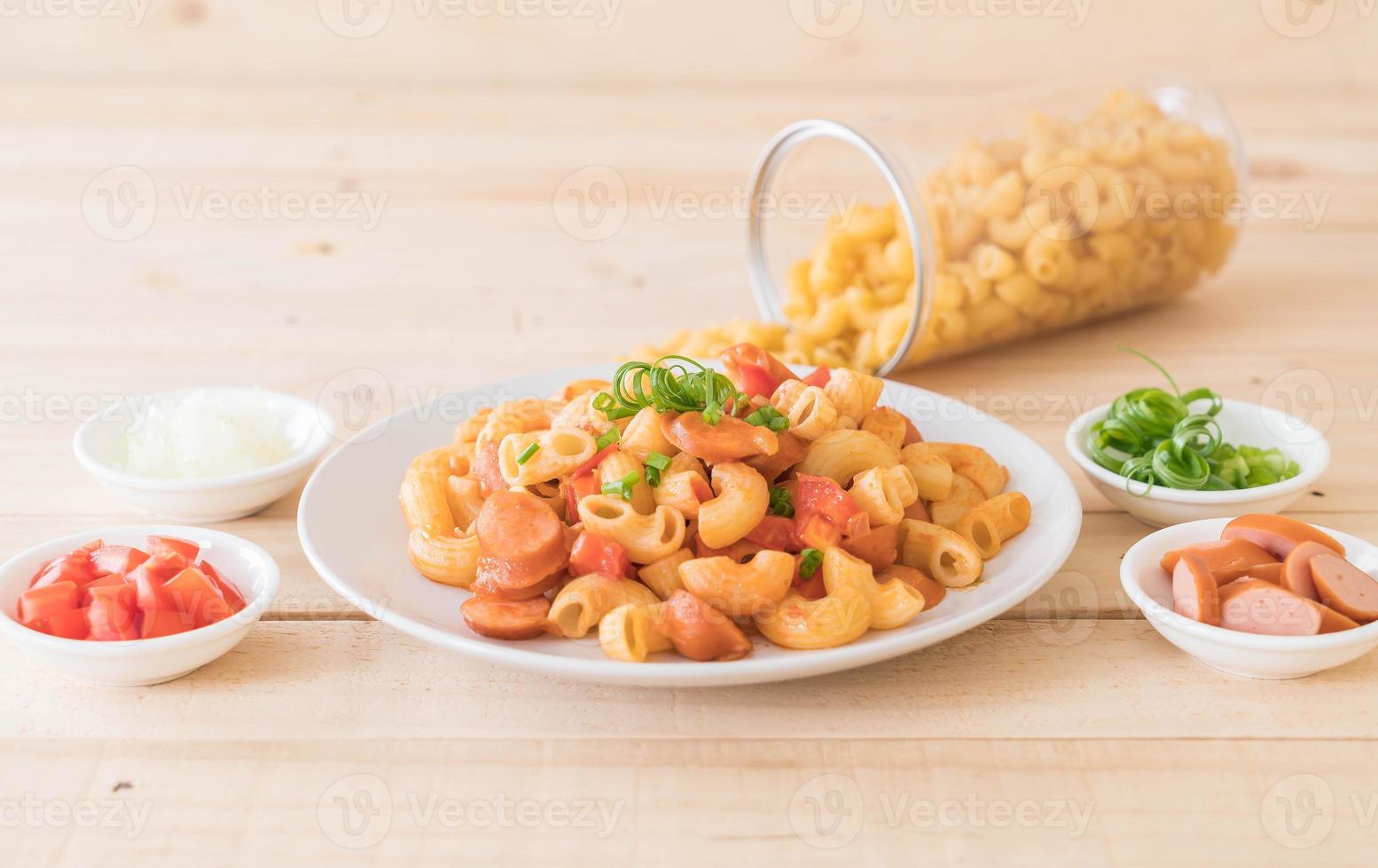 Macaroni with sausage on the table photo