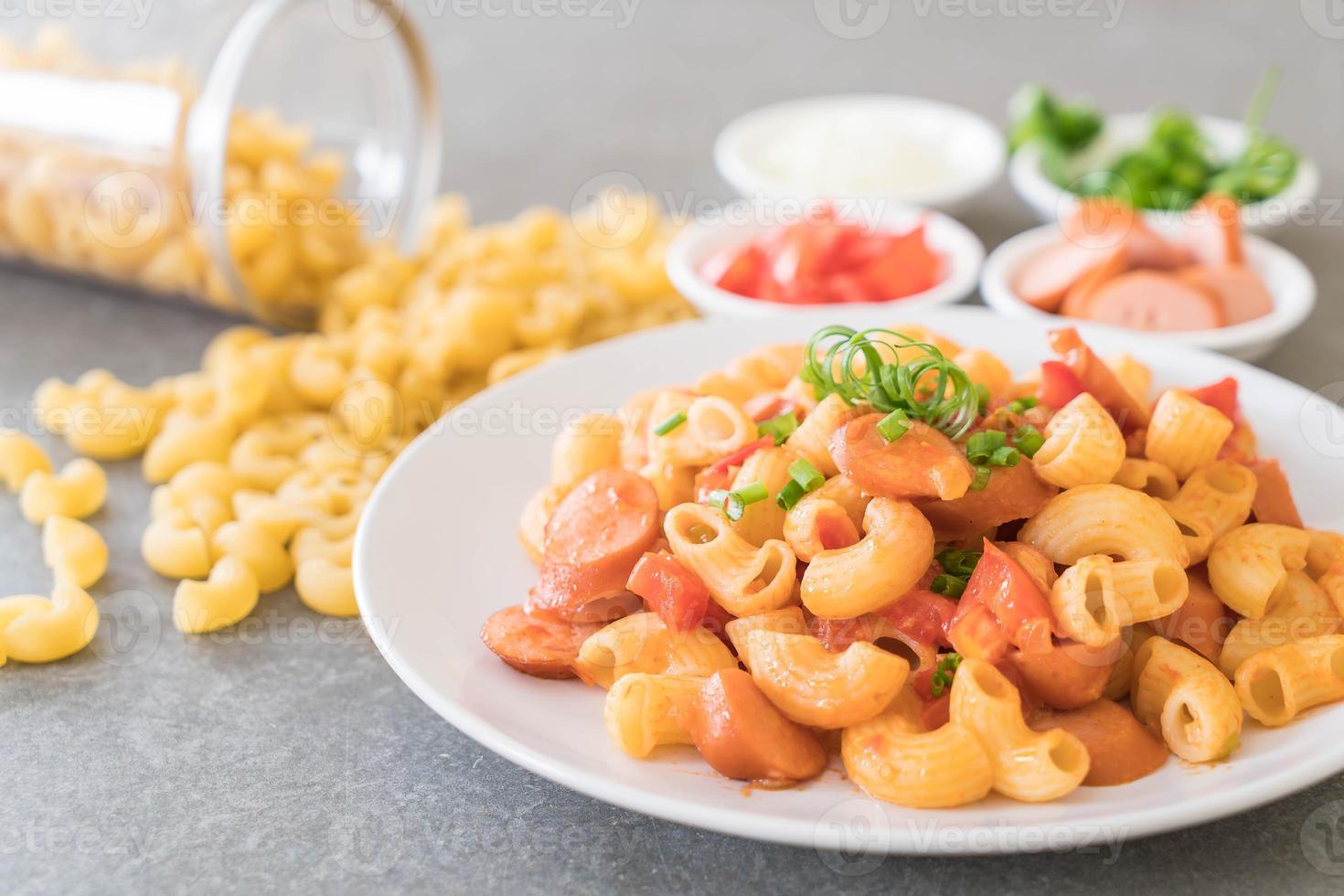 Macaroni with sausage on the table photo