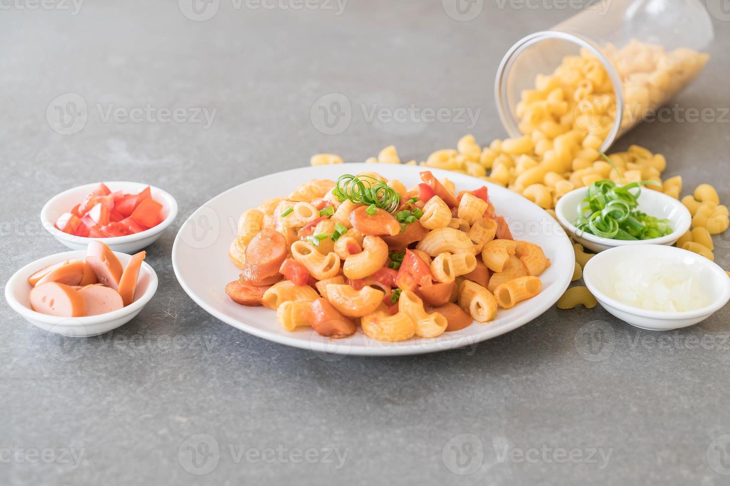 Macaroni with sausage on the table photo