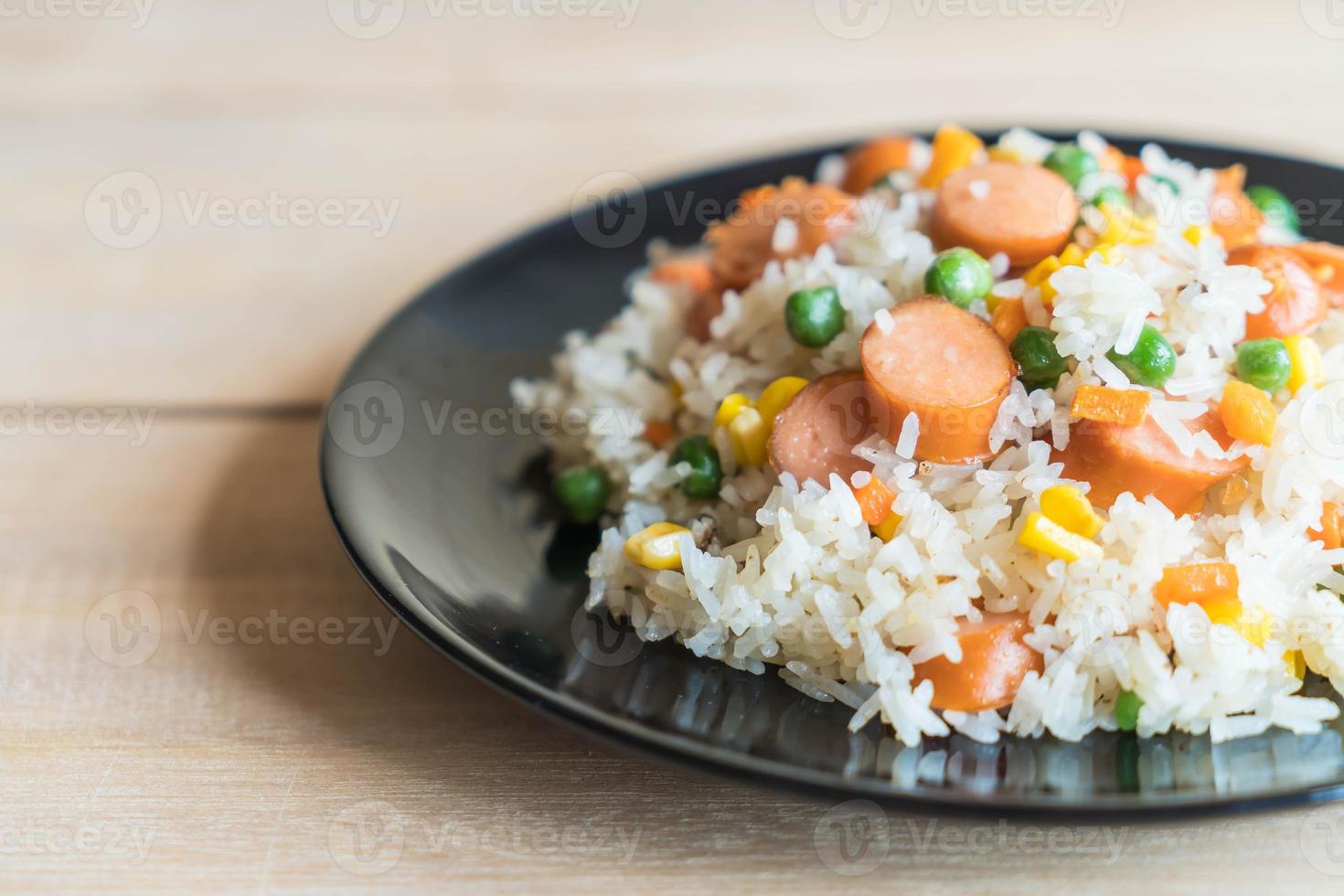 Fried rice with sausage on the table photo