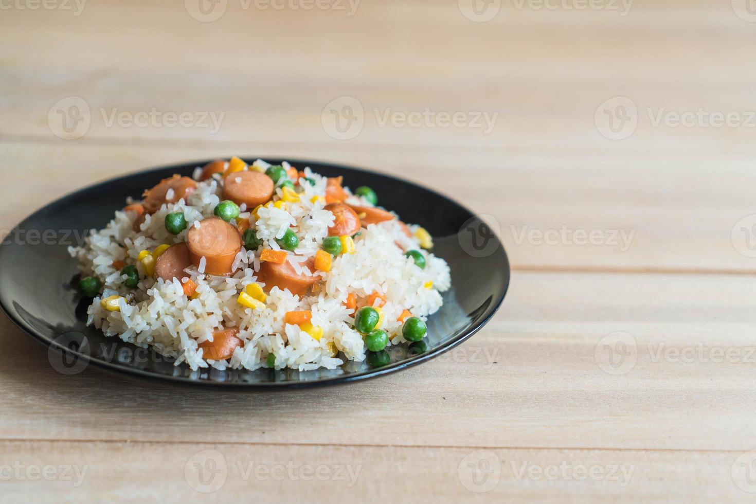 Fried rice with sausage on the table photo