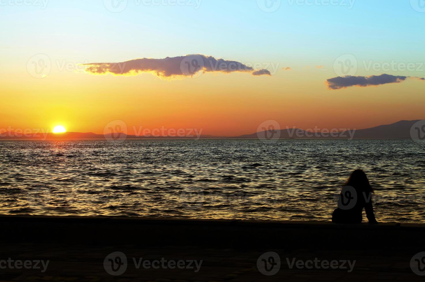 People Silhouette and the Sea in Sunset photo