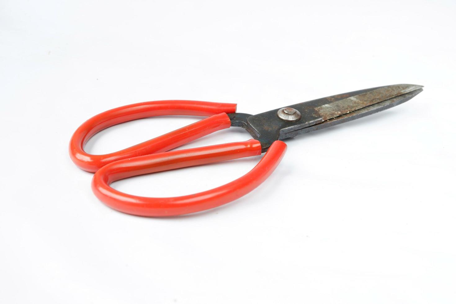 Closeup shot of scissors with red handles isolated on a white photo