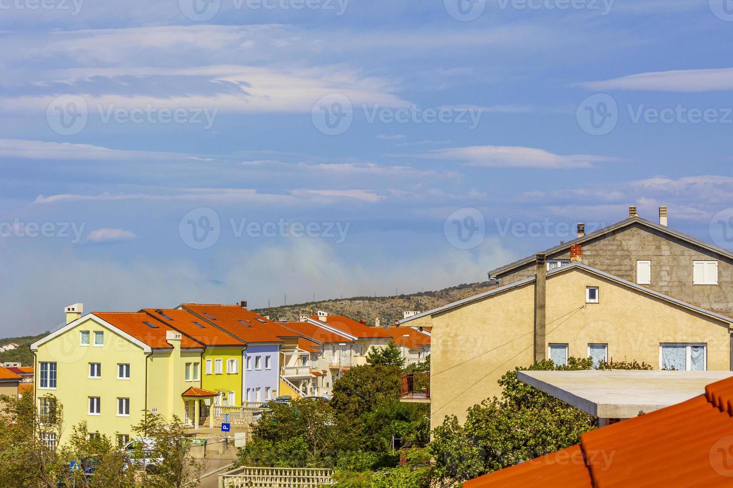 Novi Vinodolski in Croatia on a sunny day with smoke from the forest fire in the horizon photo