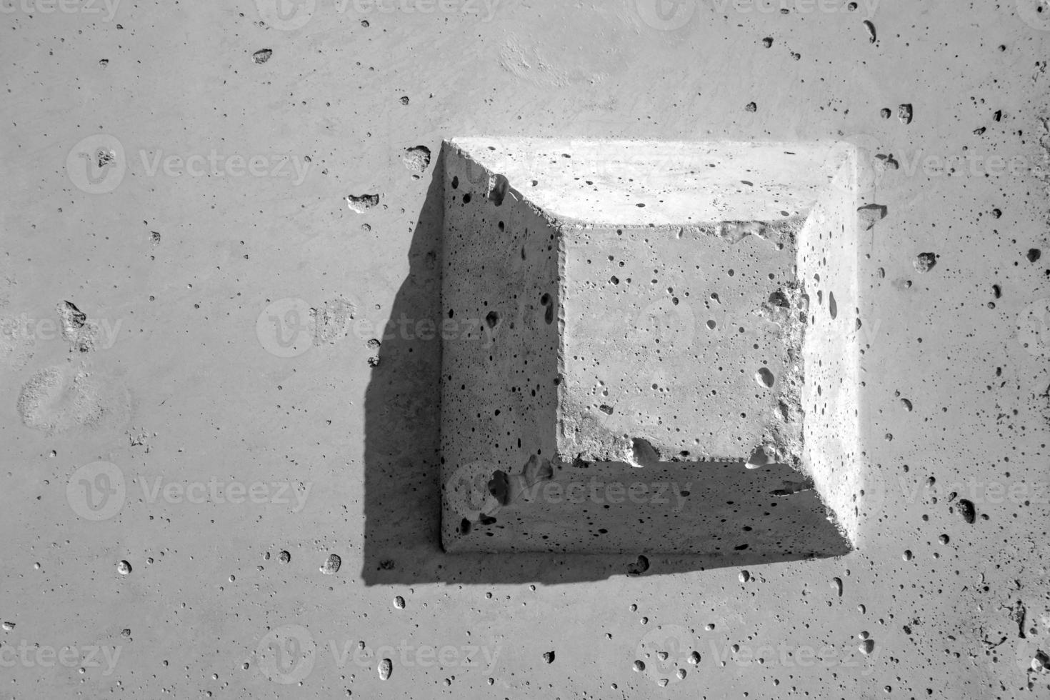 The truncated square pyramid shape on the concrete surface photo