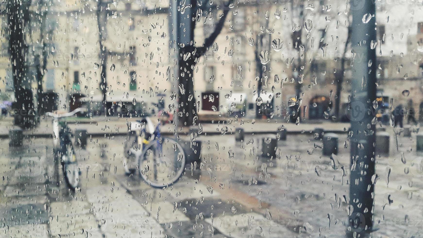 Raining in the city of Turin with drops on glass photo